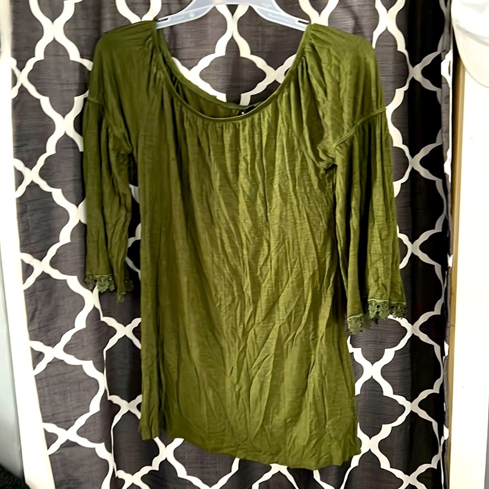 Olive green loosely fitted long sleeve shirt with lace on the bottom of sleeves